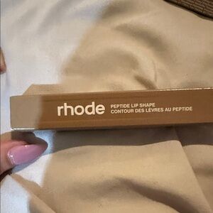 RHODE Peptide Lip Shape in Tan Packaging